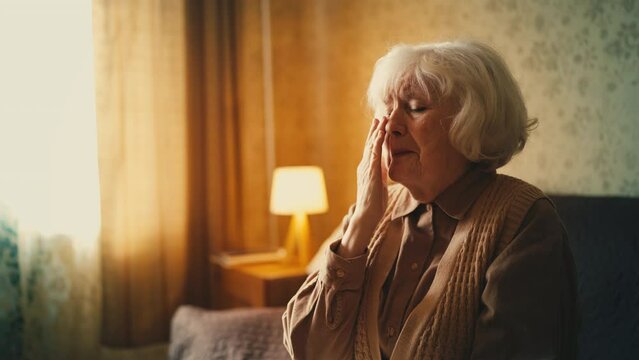 Lonely elderly woman crying at home, pain of loss, emotional stress, crisis