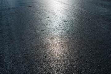 Wet asphalt after rain on a bright sunny day