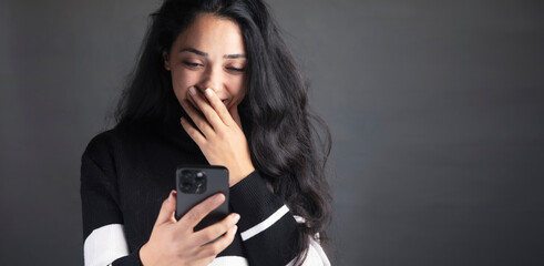 a woman talking on a cell phone with a black background