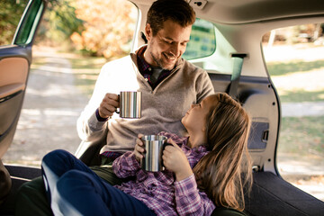 Father and daughter camping in their car in nature