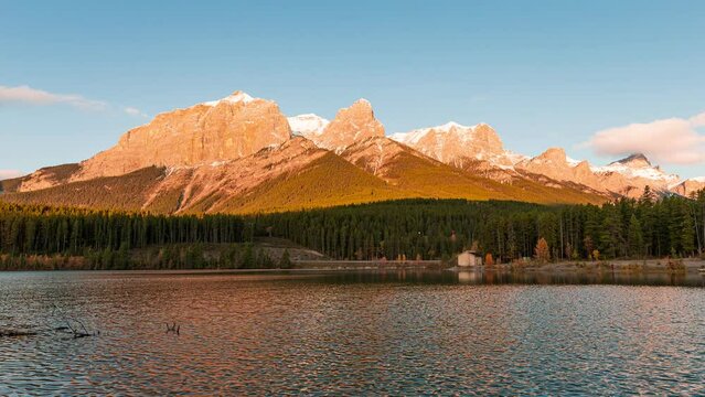Sunrise on Mount Rundle with blue sky on Rundle Forebay reservoir in autumn at Canmore, Canada