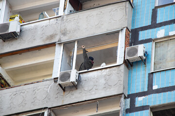 A man repairs a window after an explosion in the city of Dnepr in Ukraine, replacing a window, war, repairing
