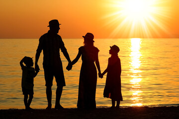 A happy family by the sea in nature silhouette weekend travel