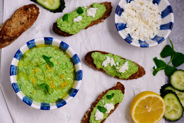 Green pea dip with feta and crostini. top view .