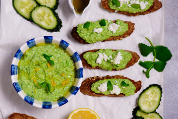 Green pea dip with feta and crostini. top view .