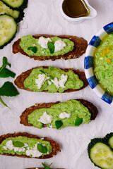 Green pea dip with feta and crostini. top view .