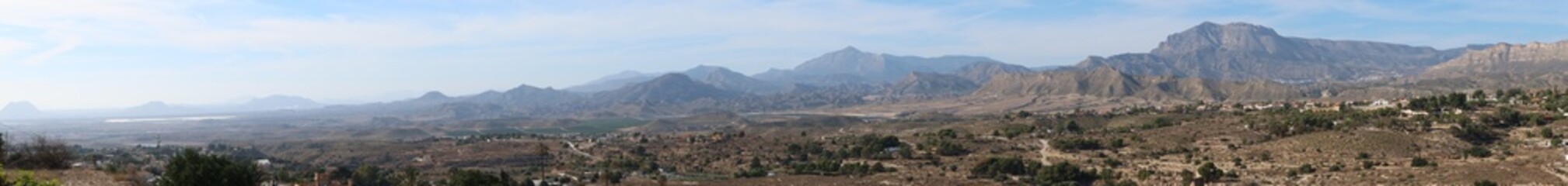 Fototapeta na wymiar Busot, Alicante, Spain, January 28, 2024: Panoramic of the many mountains that can be seen from Busot, Alicante, Spain