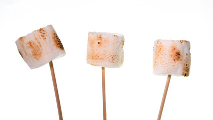 Bamboo sticks with roasted marshmallows isolated  on white background
