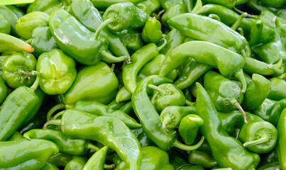 Lots of fresh green peppers. Close up background