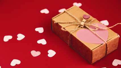 Gift box hearts on a red background. Copy space