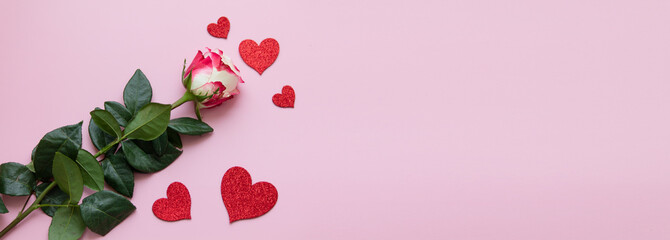 A rose and decorative hearts on a pink background, a Valentine or a greeting card, a symbol of...