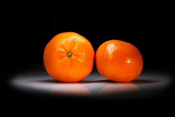 tangerines lie in the dark on the table