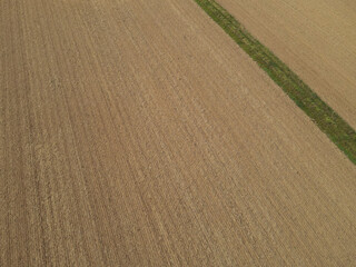 Plowed farm field with soil from above in the countryside