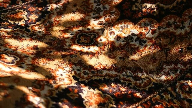 carpet texture. pattern on the carpet. set and shadow on the carpet. Close-up of the woolen fabric texture and woven Iranian rug artistic design. Detail of a handmade, traditional. abstract pattern on
