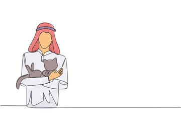 Single one line drawing of young energetic Arabian man holding a cuddle funny cat in front of his chest. The younger generation of animal lovers. Happy man petting cat. Continuous line design graphic
