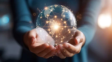 Fotobehang Pair of hands holding a transparent globe with digital connections and nodes superimposed over it, representing a network, global communication © Zahid