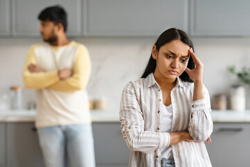 Young indian woman touching her head, have fight with husband