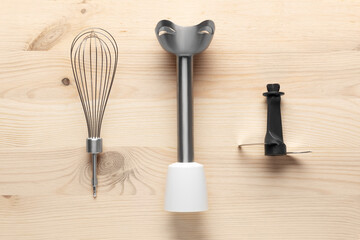 Electric hand blender on a wooden background. Top view. 