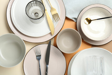 Clean plates, bowls, glasses and cutlery on table, flat lay