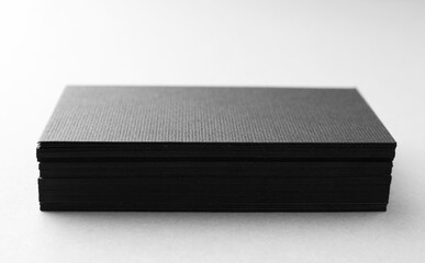Blank black business cards on white table, closeup