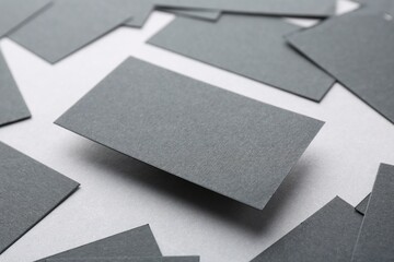 Blank black business cards on light background, closeup. Mockup for design