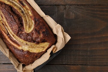Delicious banana bread on wooden table, top view. Space for text