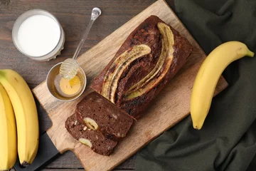 Foto op Plexiglas Delicious banana bread served on wooden table, flat lay © New Africa