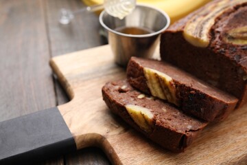 Delicious banana bread on wooden table, closeup. Space for text