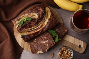 Delicious banana bread served on brown table, flat lay