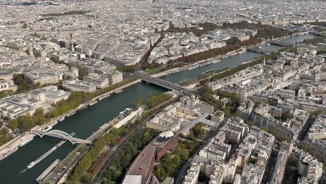 Aerial View of Paris with Seine River and Bridges, Overhead shot capturing the Seine River weaving through Paris, with bridges and historic city layout