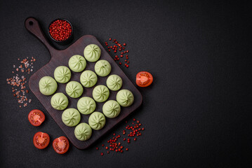 Raw khinkali or green dumplings with salt, spices and herbs