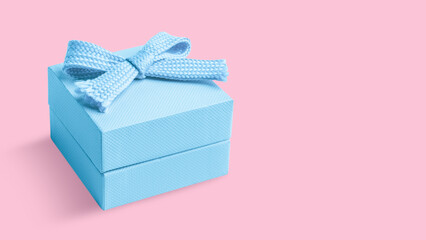 Light blue box with a bow on an pink background.