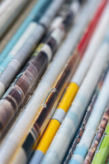 Old colored paper magazines in row, macro view