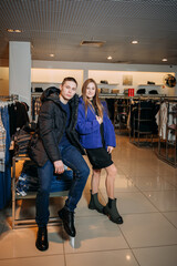 Fototapeta premium A man and a woman posing for a picture indoors. They are both smiling and standing. 5919
