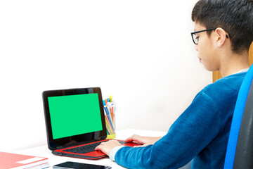 Young student using a laptop for homework attend online classes in a dedicated study space