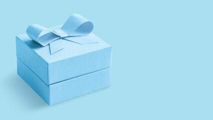 Light blue box with a bow on an Light blue background.