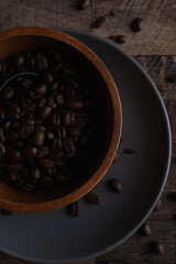 Vertical top view of a bowl of coffee beans on plate