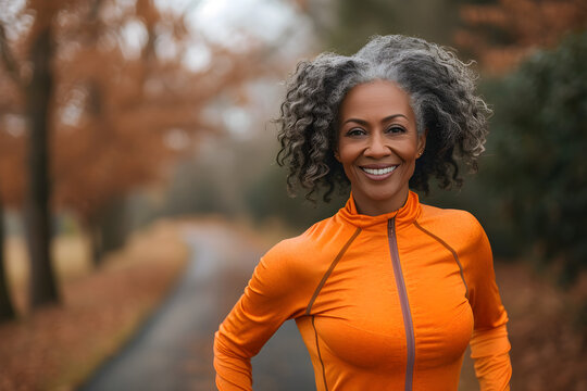 Happy middle aged African American woman enjoying outdoor exercise
