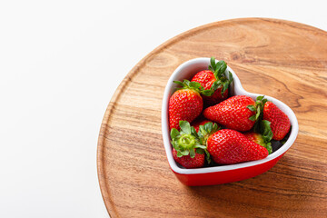 Fresh strawberries in heart bowl