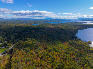 Aerial view of Lake Winnipesaukee with sunshine through clouds in fall from town of Moutonborough, New Hampshire NH, USA. 
