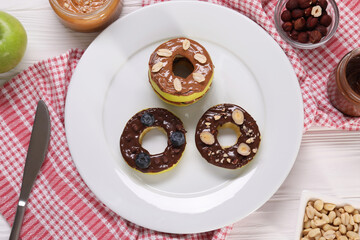 Fresh apples with nut butters, blueberries and nuts on white wooden table, flat lay