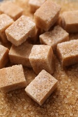 Different types of brown sugar as background, closeup