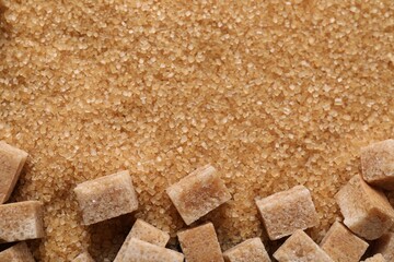 Different types of brown sugar as background, top view. Space for text
