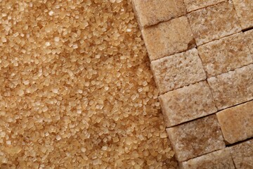Different types of brown sugar as background, top view. Space for text