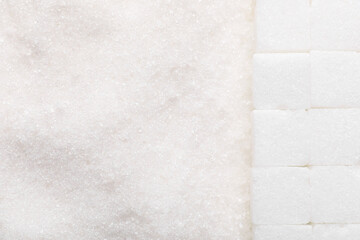 Fototapeta premium Different types of white sugar as background, top view. Space for text