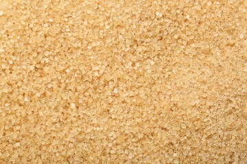 Granulated brown sugar as background, top view