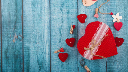 Wooden blue background with red hearts, gifts and candles. Valentine's Day concept. Copy space
