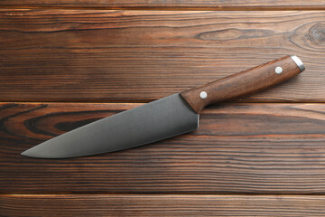 One knife on wooden table, top view