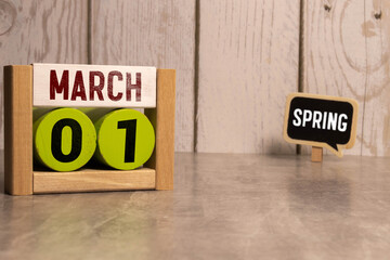 March 1 calendar date text on wooden blocks with blurred park background. Copy space and calendar...