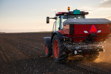 Tractor spreading artificial fertilizers